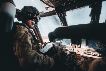 A UH-60 Black Hawk helicopter pilot, assigned to the 25th Combat Aviation Brigade, looks toward his co-pilot during flight operations in Kauai, Hawaii, Oct. 13, 2021. The 25th Combat Aviation Brigade provides Multifunctional Aviation support to the 25th Infantry Division to conduct Decisive Actions in support of Unified Land Operations.