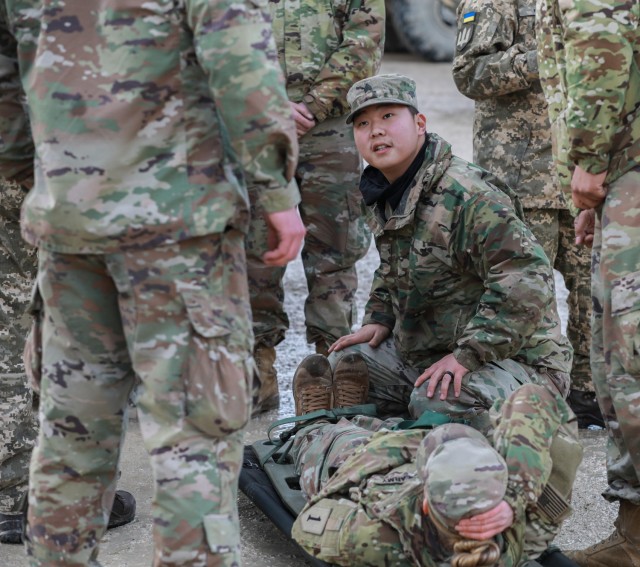 U.S. Army Sgt. Jong Han, a combat medic with 1st Battalion, 16th Infantry Regiment “Iron Rangers,” 1st Armored Brigade Combat Team, 1st Infantry Division, provides a visual representation of the effective uses of patient litters during medical training with the 92nd Mechanized Brigade, Ukrainian Army combat medics in preparation for the field exercises of Combined Resolve XVI at the Joint Multinational Readiness Center in Hohenfels, Germany, Dec. 2, 2021. Approximately 4,500 soldiers from 12 nations are participating in Combined Resolve XVI, with participation from Bulgaria, Georgia, Greece, Italy, Lithuania, Poland, Serbia, Slovenia, Ukraine, United Kingdom, and the United States.