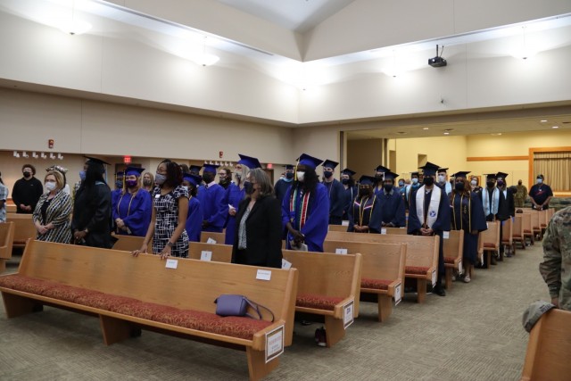 Graduates from the 2 p.m. graduation ceremony stand for the beginning of the ceremony in the Cache Creek Chapel Dec. 2, 2021. Altogether around 125 students participated in the graduation ceremony on Fort Sill.