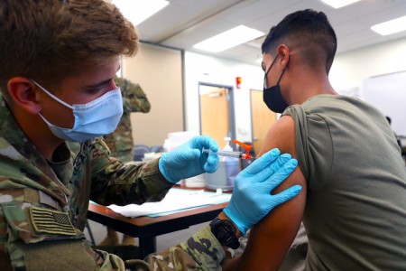 Army Spc. Tyler Boyer administers the COVID-19 vaccine to another soldier at Fort Carson, Colo., Aug 3, 2021. Soldiers remain committed to keeping the Fort Carson community safe and healthy by offering COVID-19 vaccines at mobile vaccination centers.