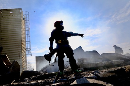 A Soldier and engineer from the 409th Engineer Company, based in Aurora, Colo., stands on a pile of rubble during exercise Guardian Response 21, directing his fellow Soldiers where to look for possible survivors in a simulated building collapse at the Muscatatuck Urban Training Center in Butlerville, Ind.