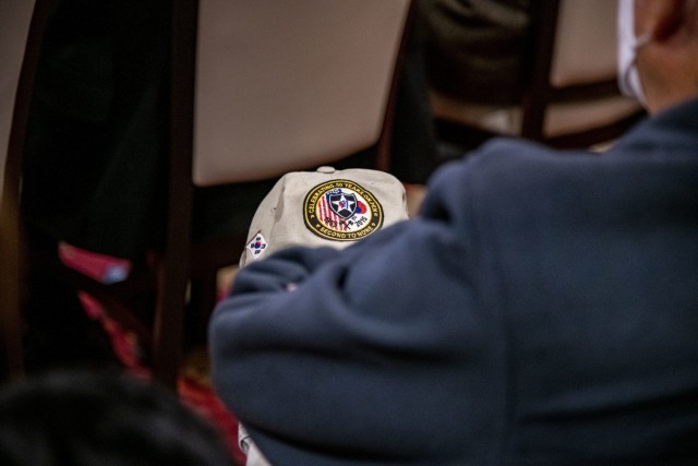 David Beam, a U.S. Forces Korea veteran, rests his 2nd Infantry Division hat on his knee during the Republic of Korea Ministry of Patriots and Veterans Affairs Revisit Korea program orientation at Camp Humphreys Dec. 3, 2021.