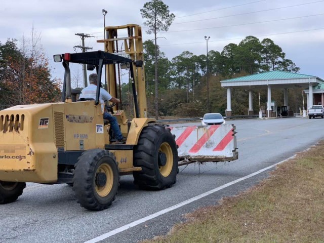 A forklift operator from the Directorate of Public Works places a concrete barrier at Britt gate, Dec. 7 on Fort Stewart. The barriers were the capstone event of this year’s integrated installation protection exercise. (Photo by Beau Bradley)