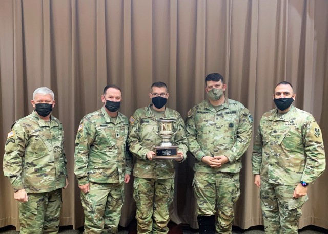 The 554th Engineer Battalion are the winners of the 2021 Commander’s Cup trophy. Maj. Gen. James Bonner, Maneuver Support Center of Excellence and Fort Leonard Wood commanding general (left), and MSCoE and Fort Leonard Wood Command Sgt. Maj. Randolph Delapena (right) presented the trophy Dec. 6 in the Commander’s Briefing Room to Lt. Col. John Moran, 554th En. Bn. commander (second from left), 554th En. Bn. Command Sgt. Maj. Delmont Stephens (center), and Staff Sgt. Aaron McWilliams, 554th En. Bn. Operations NCO and the battalion’s sports representative. Considered Fort Leonard Wood’s highest sports honor, the Commander’s Cup is presented to the unit with the most accumulated points across a variety of team sports events. Participation in the Commander’s Cup program is open to all active-duty military personnel, dependents ages 18 and older who are out of high school, retirees and Department of Defense civilians. Teams must be made up of personnel from the same unit and consist of 75 percent active-duty personnel throughout the season. For information about the program, contact Danny Howell, FMWR sports specialist, at 573.596.7762, or by email at danny.r.howell4.naf@army.mil. 