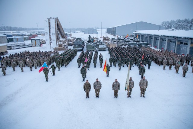 Soldiers with 3rd Battalion, 66th Armored Regiment (3-66), 1st Armored Brigade Combat Team, 1st Infantry Division and soldiers from multiple nations stand in formation at the closing ceremony for Winter Shield 2021 at Camp Ādaži, Ādaži,...