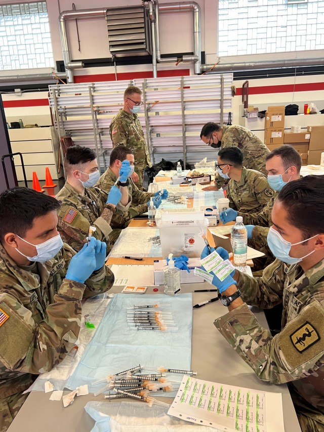 Soldiers from the 30th Medical Brigade, 21st Theater Sustainment Command, joined Service Members from Landstuhl Regional Medical Center and Ramstein Air Force Base to pre-fill syringes with COVID-19 vaccine during a Booster Shot Rodeo at Kleber...