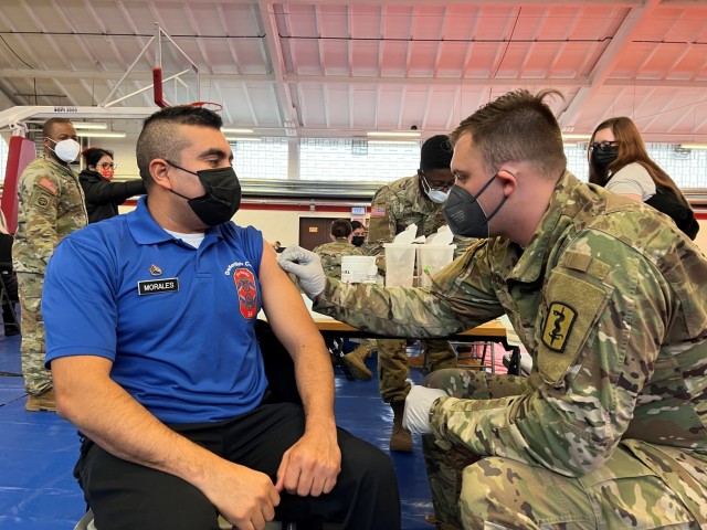 PFC Timothy Puckett, 512th Field Hospital, preps Staff Sgt. Jorge Morales, 55QM, 16th Sustainment Brigade, for his COVID-19 booster shot during a Booster Rodeo at Kleber Gym, Kaiserslautern, Germany, on December 8, 2021. Soldiers from the 30th...