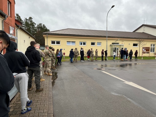 Walk-ins waited in line to get voluntary COVID-19 booster shots at the December 8, 2021 vaccine rodeo at Kleber Gym, Kaiserslautern, Germany. 30th Medical Brigade Victory Medics helped manage patient flow, checked paperwork and eligibility,...