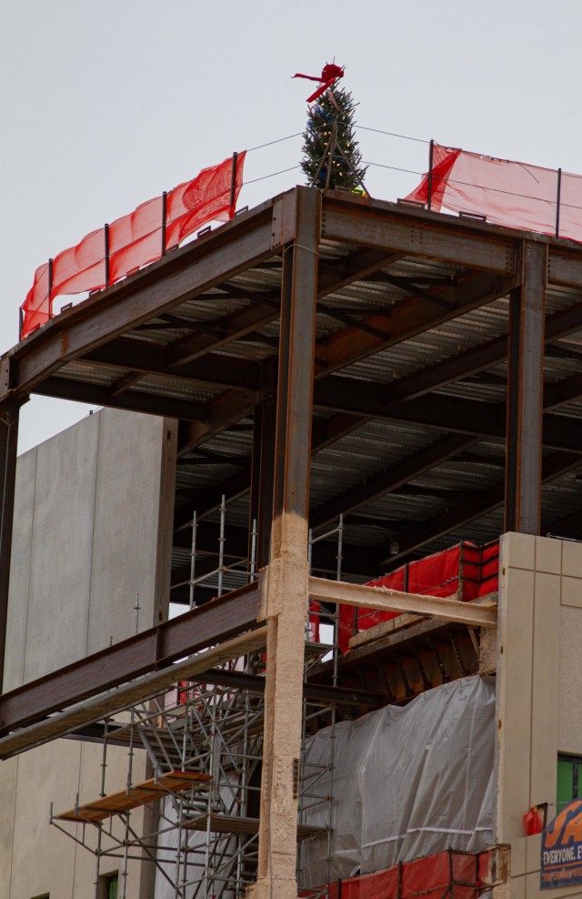 A tree is illuminated on top of the General Leonard Wood Community Hospital Project to represent the placement of the final piece of structural steel and partnerships during a Topping Out Ceremony at Fort Leonard Wood on Dec. 7, 2021.