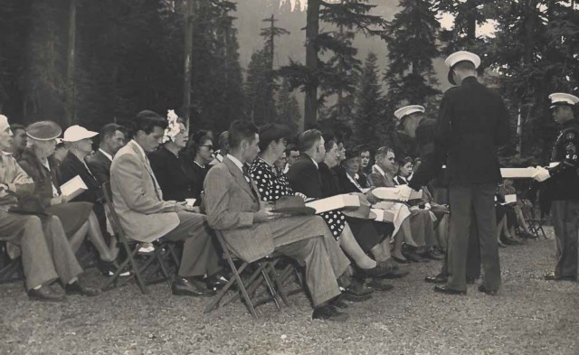 Relatives of 32 U.S. Marines killed in a plane crash on Mount Rainier Dec. 10, 1946, receive memorial flags at the service at Round Pass held Aug. 24, 1947.