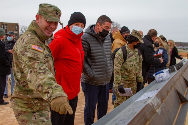 U.S. Army Corps of Engineers, Kansas City District, Deputy Commander Lt. Col. John Chambers (left) shows Military Programs Chief Tim Kurgan (middle) and Engineer Chief Eric Shumate (right) signatures on the last piece of structural steel for the...