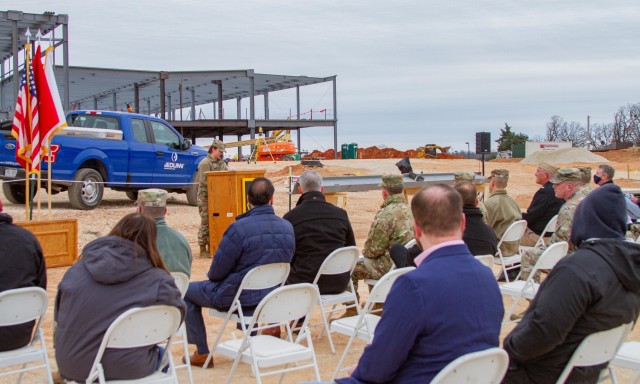 Personnel from the Department of Defense, U.S. Army, U.S. Army Corps of Engineers, JE Dunn Construction, RLF Architecture and Fort Leonard Wood gather to recognize the placement of the final piece of structural steel on the General Leonard Wood...