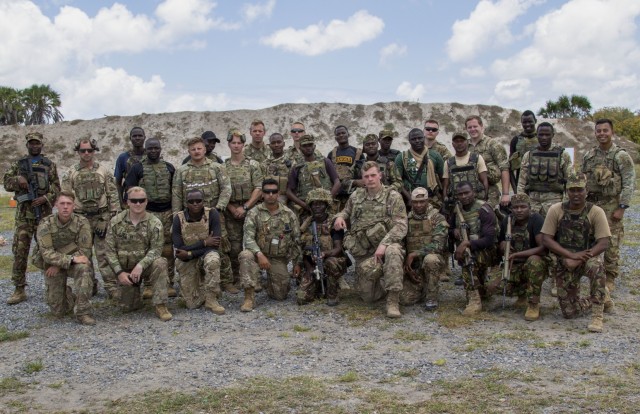 U.S. Army Soldiers assigned to C Company, 1-102nd Infantry Regiment (Mountain), Task Force Iron Gray, Combined Joint Task Force – Horn of Africa (CJTF-HOA) and service members with the Kenya Defence Forces come together for a group photo...