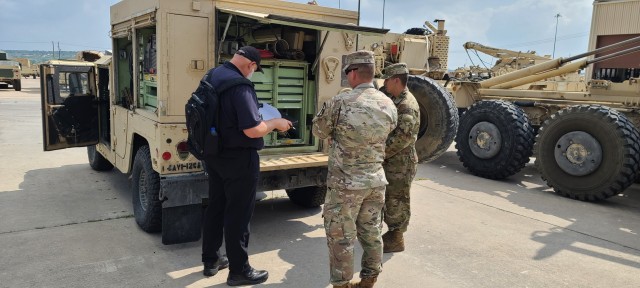 A Ground Readiness Evaluation Assessment and Training Team guest evaluator from the Fort Hood Command Maintenance Evaluation and Training Team verifies PMCS, tools, and equipment on a Shop Equipment Contact Maintenance vehicle June 21 with members...