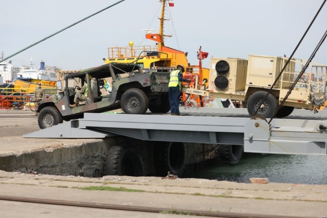 Equipment belonging to 53rd Infantry Brigade Combat Team arrives at the port of Durres May 1 on the U.S. Army Logistics Support Vessel Maj. Gen. Charles P. Gross (LSV 5), while it was operating in the Adriatic Sea during DEFENDER-Europe 21. 