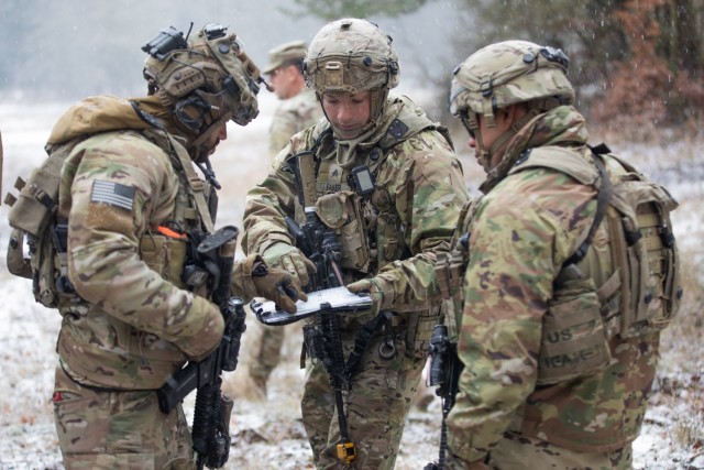 U.S. Army Sgt. Devon Eaker (center), a joint fire support specialist with 1st Battalion, 5th Field Artillery Regiment, 1st Armored Brigade Combat Team, 1st Infantry Division, coordinates with members of the COLT (Combat Observation Lasing Team), as they prepare for missions during Combined Resolve XVI at the Joint Military Readiness Center (JMRC) in Hohenfels, Germany, Dec. 8, 2021. The teams are part of the force-on-force exercise portion of Combined Resolve, which includes approximately 4,600 armed forces service members from Bulgaria, Georgia, Greece, Italy, Lithuania, Poland, Serbia, Slovakia, Slovenia, Ukraine, United Kingdom and the United States. The operations are being conducted by integrated battalions with multinational units operating under a unified command and control element, allowing the U.S., its allies and partners to experience invaluable training alongside each other. 