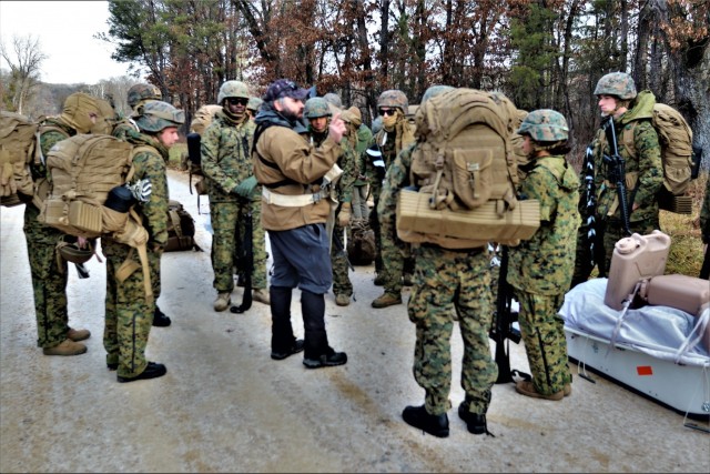 Instructor Hunter Heard talks with Marines with the 6th Marine Regiment of Camp Lejeune, N.C., during training Dec. 1, 2021, in the Cold-Weather Operations Course (CWOC) Class 22-01 at Fort McCoy, Wis. More than 150 Marines participated in the...