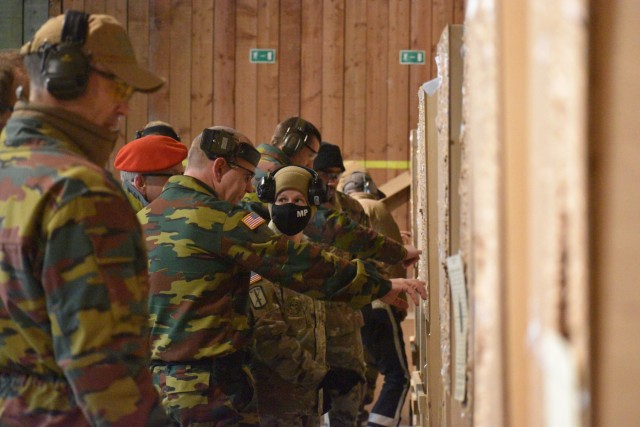 Sgt. 1st Class Jerri Lynn Daniels, center right, U.S. Army Garrison Benelux – Brussels provost sergeant and Directorate of Emergency Services noncommissioned officer in charge, reviews the grouping shots by with Belgian armed forces 1st Sgt....