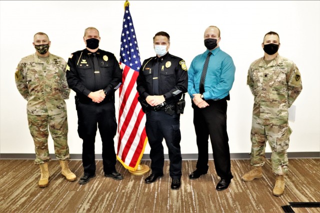 Lt. Benjamin Finn and Sgt. Kevin Eckelberg with the Fort McCoy (Wis.) Directorate of Emergency Services Police Department are recognized Dec. 2, 2021, by Garrison Commander Col. Michael Poss as part of the Garrison Command Team who presented the...