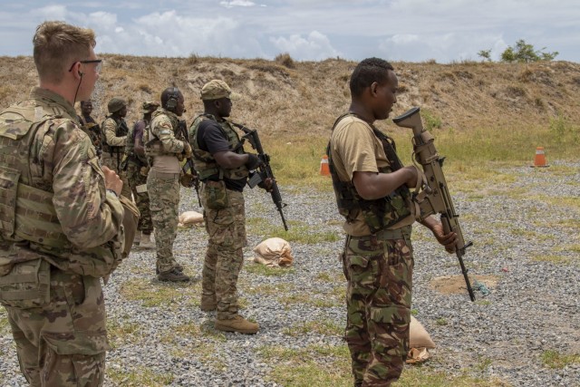 U.S. Army Spc. David Fox, assigned to C Company, 1-102nd Infantry Regiment (Mountain), Task Force Iron Gray, Combined Joint Task Force – Horn of Africa (CJTF-HOA), watches as service members assigned to the Kenya Defence Forces begin the next...