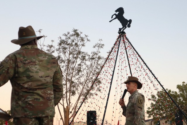 Col. Todd Hook, Regimental Commander, speaks into a microphone prior to lighting the Regimental Tree at Wickam Park, Fort Irwin, Calif., on December 2, 2021. The Regimental Tree Lighting was held in conjunction with the award ceremony for the...