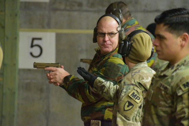Sgt. 1st Class Jerri Lynn Daniels, center right, U.S. Army Garrison Benelux – Brussels provost sergeant and Directorate of Emergency Services noncommissioned officer in charge, discusses marksmanship with Belgian armed forces 1st Sgt. Kris...