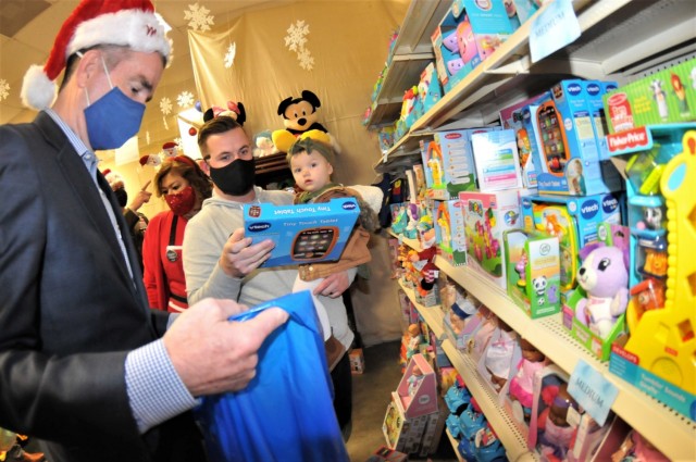 Virginia Governor Ralph Northam helps Spc. Steven Mallotte shop for gifts during the Holiday Helper open house event Dec. 10 at the organization’s toy warehouse on Battle Drive. Northam has participated in Holiday Helper all four years he has been in office.