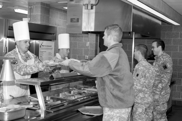 Fort McCoy Garrison Commander Col. Steven Nott and Command Sgt. Maj. Bill Bissonette, garrison command sergeant major, serve a Thanksgiving meal to installation Soldiers on Nov. 15, 2012, at Dining Facility 50.