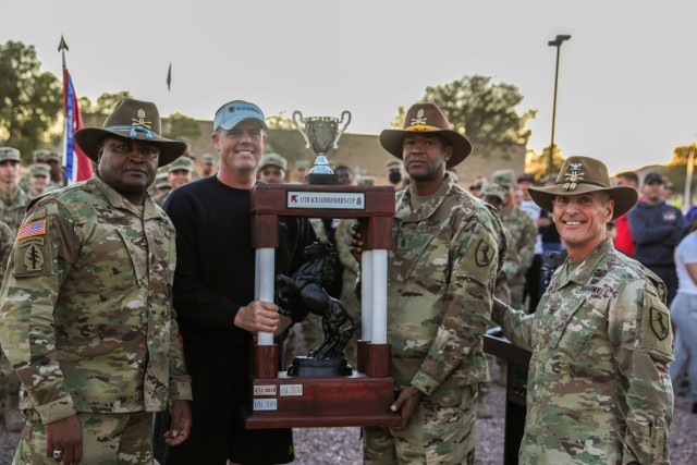 Col. Todd Hook, Regimental Commander, and Command Sgt. Maj. Anthony Walker present Lt. Col. Robert Furtick, Commander, 1st Squadron, and Command Sgt. Maj. Frederick Batiste, Enlisted Advisor, 1st Squadron, the Commander's Cup in Wickam Park, Fort Irwin, Calif. on December 2, 2021. The Commander's Cup will be held in the 1st Squadron area of operations for the next year, until the next Commander's Cup tournament.