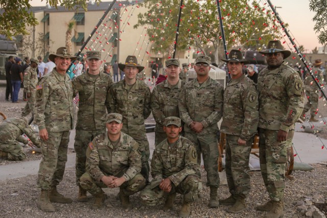 Regimental Commander, Col. Todd Hook, and Regimental Command Sergeant Major, Command Sgt. Maj. Anthony Walker, pose for a group photo with the Troopers that designed and built the Regimental Tree displayed in Wickam Park, Fort Irwin, Calif., on December 2nd, 2021: (from left to right, top) Spc. Thomas Horsey, Staff Sgt. Andrew Reeves, Spc. Jacob Allen, Spc. Jacob Sarabia, Warrant Officer William Nicely, (from left to right, bottom) Sgt. Smays Jauregui, and Sgt. Cesar Juarez. The Regimental Tree is the centerpiece of Wickam Park's holiday makeover.