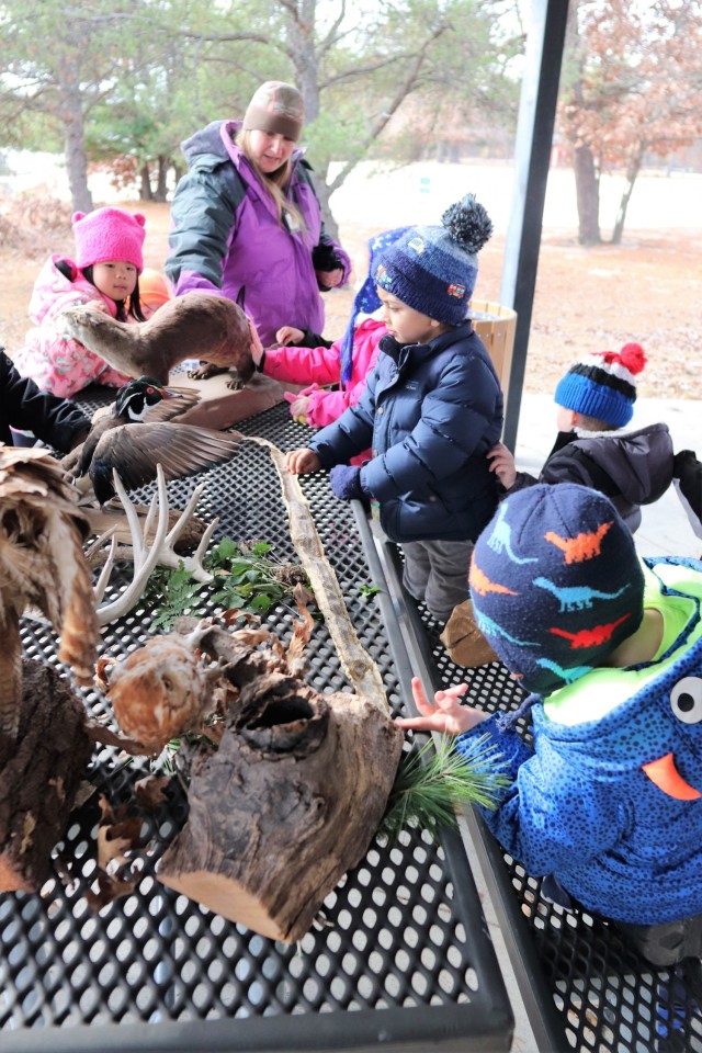 Children participating in the USO Wisconsin’s Hike and Hunt event Nov. 17, 2021, at Fort McCoy, Wis., look at taxidermy mounts that relate to animals of Wisconsin. The items were brought to the event by Natural Resources Specialist Kevin Luepke...