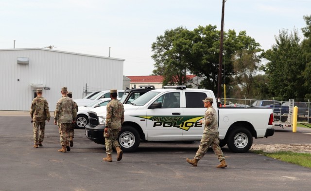 Military police assigned to work with the Fort McCoy Garrison Directorate of Emergency Services (DES) Police Department head to a meeting place Sept. 2, 2021, at Fort McCoy, Wis. DES augmented its police force with the 411th Military Police...