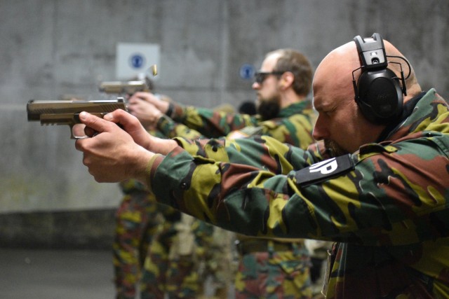 Adjutant Peter Van Den Block, a reservist with the Belgian armed forces who also works with the U.S. Department of State, fires an M17 service pistol. U.S. Army military police Soldiers helped their Belgian counterparts qualify on U.S. Army...