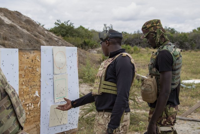 Service members assigned to the Kenya Defence Forces inspect a target for bullet impact during urban rifle marksmanship training at Manda Bay, Kenya, Oct. 2, 2021. CJTF-HOA, operating from Camp Lemonnier, Djibouti, regularly trains with and works...