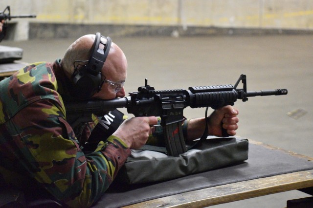 Adjutant Peter Van Den Block, a reservist with the Belgian armed forces who also works with the U.S. Department of State, fires a round. U.S. Army military police Soldiers helped their Belgian counterparts qualify on U.S. Army weapons Dec. 7 at a...