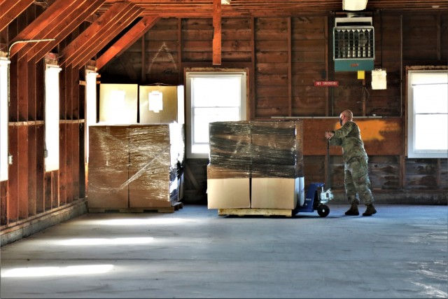 Soldiers with the 181st Multifunctional Training Brigade stack pallets of donated clothing from the Islamic Society of Milwaukee in a building at Fort McCoy, Wis., to be used by Afghan evacuees on Sept. 18, 2021. The building is regularly managed...