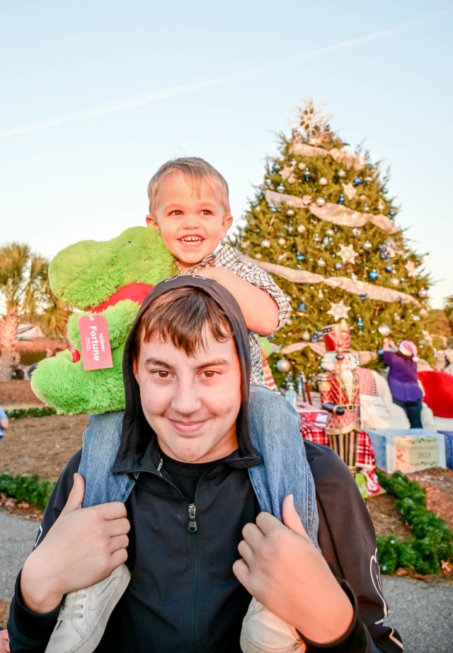 Conner Bragg gets the best seat in the house by sitting on his brother Jacob's shoulders during the annual Holiday Tree Lighting Ceremony Dec. 3, 2021, at Fort Jackson, South Carolina.