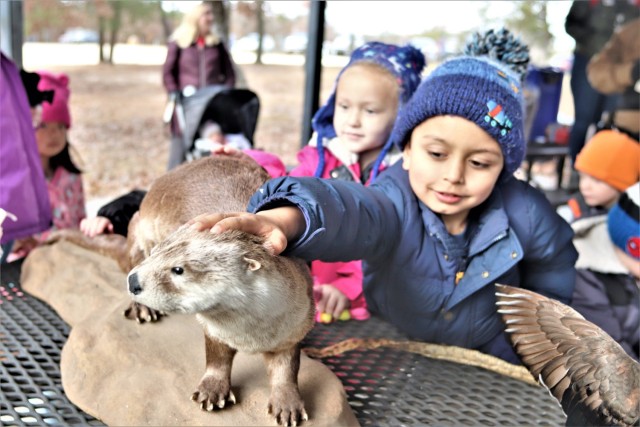 Children participating in the USO Wisconsin’s Hike and Hunt event Nov. 17, 2021, at Fort McCoy, Wis., look at taxidermy mounts that relate to animals of Wisconsin. The items were brought to the event by Natural Resources Specialist Kevin Luepke...