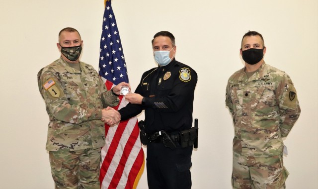 Lt. Benjamin Finn receives a Commander's Coin of Excellence on Dec. 2, 2021, from Fort McCoy (Wis.) Garrison Commander Col. Michael Poss as part of the Garrison Command Team who presented the coin for being selected to the fiscal year 2022 Defense...