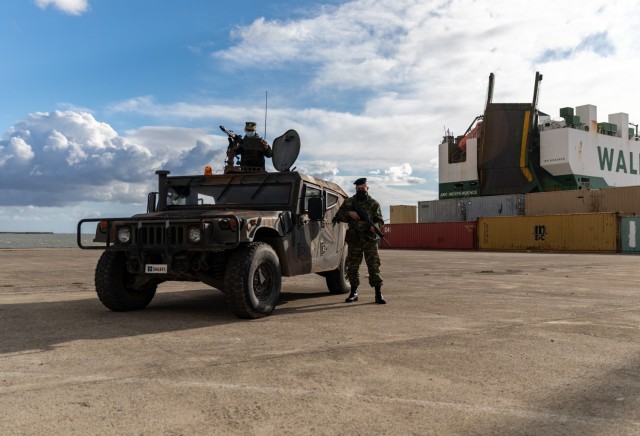 Hellenic Army soldiers provide onsite security for U.S. Army Soldiers, as equipment is transferred to and from the vessel ARC Independence at the port of Alexandroupoli, Greece, Nov. 30, 2021. Through coordination with allies and partners, U.S. Army Europe and Africa maintains access for large-scale military movements into and throughout the theater. 