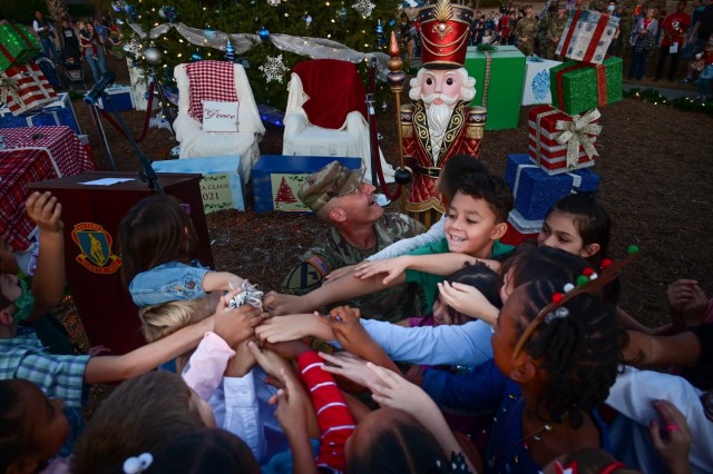 U.S. Army Training Center and Fort Jackson Commanding General Brig. Gen. Patrick R. Michaelis and students from C.C. Pinckney Elementary School choir flip the switch to officially light the tree during the annual Holiday Tree Lighting Ceremony....