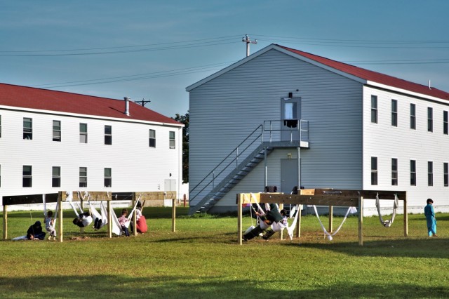 Afghan children play on makeshift swings made from clotheslines and blankets Sept. 13, 2021, at Fort McCoy, Wis. The children's play area is in one of many barracks blocks at the post that are managed by the Fort McCoy Directorate of Public Works....