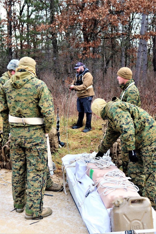 Instructor Hunter Heard talks with Marines with the 6th Marine Regiment of Camp Lejeune, N.C., during training Dec. 1, 2021, in the Cold-Weather Operations Course (CWOC) Class 22-01 at Fort McCoy, Wis. More than 150 Marines participated in the...
