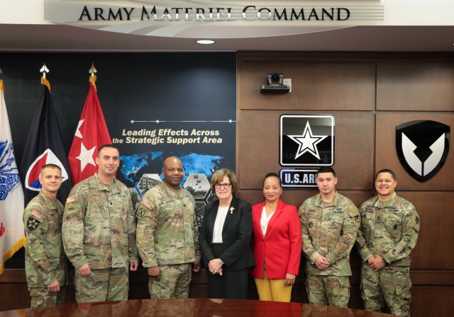 Pam Lang, center, is proud of the command teams she has worked with during her 10 years at Army Materiel Command. Lang, who is the executive assistant to AMC Commander Gen. Ed Daly, is retiring after 29 years of service. She is leaving a command team that includes, from left, Master Sgt. Randy Leyba, Lt. Col. Ramon Salas, Col. Landis Maddox, Andrea Turner, Chief Warrant Officer 3 Edwin Lopez, Lopez and Staff Sgt. Bryan Reeves. (U.S. Army Photo by Eben Boothby)