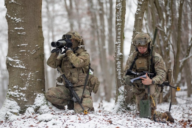 U.S. Army Pfc. Kyle Lavorante (left) and Spc. Jakeb Tadlock, Joint Fire Support Specialists with Bravo Company, 1st Battalion, 16th Infantry Regiment, 1st Armored Brigade Combat Team, 1st Infantry Division, observe and report via radio as part of a COLT (Combat Observation Lasing Team) for Combined Resolve XVI at the Joint Military Readiness Center (JMRC) in Hohenfels, Germany, Dec. 8, 2021. The teams are part of the force-on-force exercise portion of Combined Resolve XVI, which includes approximately 4,600 armed forces service members from Bulgaria, Georgia, Greece, Italy, Lithuania, Poland, Serbia, Slovakia, Slovenia, Ukraine, United Kingdom and the United States. The operations are being conducted by integrated battalions with multinational units operating under a unified command and control element, allowing the U.S., its allies and partners to experience invaluable training alongside each other. 