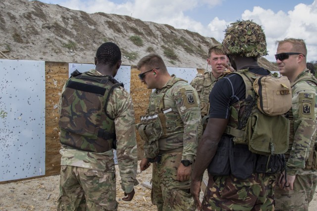 U.S. Army Soldiers assigned to C Company, 1-102nd Infantry Regiment (Mountain), Task Force Iron Gray, Combined Joint Task Force – Horn of Africa (CJTF-HOA) and service members assigned to the Kenya Defence Forces inspect a target for bullet...