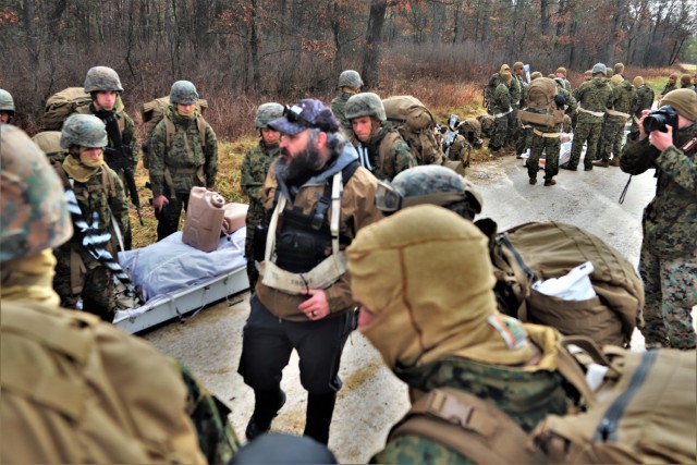 Instructor Hunter Heard talks with Marines with the 6th Marine Regiment of Camp Lejeune, N.C., during training Dec. 1, 2021, in the Cold-Weather Operations Course (CWOC) Class 22-01 at Fort McCoy, Wis. More than 150 Marines participated in the...