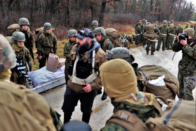 Instructor Hunter Heard talks with Marines with the 6th Marine Regiment of Camp Lejeune, N.C., during training Dec. 1, 2021, in the Cold-Weather Operations Course (CWOC) Class 22-01 at Fort McCoy, Wis. More than 150 Marines participated in the...