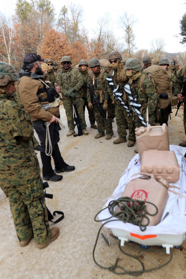 Instructor Hunter Heard talks with Marines with the 6th Marine Regiment of Camp Lejeune, N.C., during training Dec. 1, 2021, in the Cold-Weather Operations Course (CWOC) Class 22-01 at Fort McCoy, Wis. More than 150 Marines participated in the...