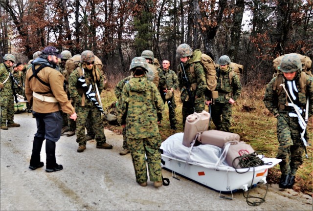Instructor Hunter Heard talks with Marines with the 6th Marine Regiment of Camp Lejeune, N.C., during training Dec. 1, 2021, in the Cold-Weather Operations Course (CWOC) Class 22-01 at Fort McCoy, Wis. More than 150 Marines participated in the...